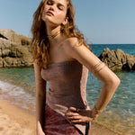 Over-the-shoulder lookbook image of a model wearing a delicate, hand-sculpted pendant necklace from the Júlia Duran workshop in Barcelona.