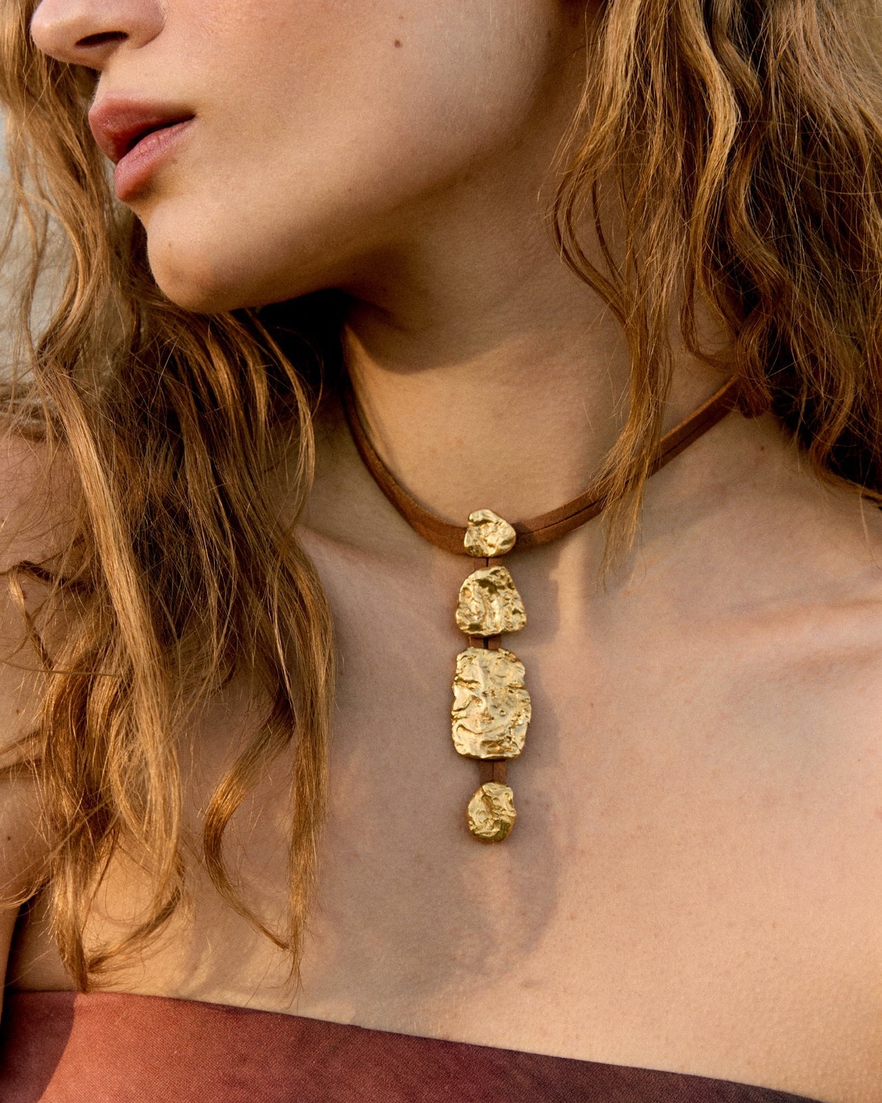 Artistic fashion composition highlighting sustainable jewelry from the Halos collection by Júlia Duran in a minimalist Mediterranean setting.