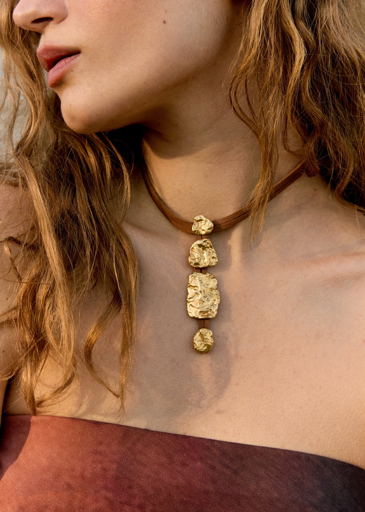 Artistic fashion composition highlighting sustainable jewelry from the Halos collection by Júlia Duran in a minimalist Mediterranean setting.